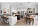 Bright kitchen with white cabinets, stainless steel appliances, granite countertops, and an adjacent dining area at 1613 Glenwick Dr, Windermere, FL 34786