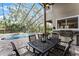 Outdoor dining and entertainment area with pool and screened enclosure at 1613 Glenwick Dr, Windermere, FL 34786
