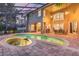 Outdoor living space with a pool, spa, built-in grill, and plenty of seating, perfect for entertaining at 1613 Glenwick Dr, Windermere, FL 34786