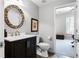 Elegant powder room featuring a decorative mirror and a glimpse into the home office at 1613 Glenwick Dr, Windermere, FL 34786
