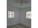 This bedroom has a ceiling fan, two windows with blinds, and tile flooring at 1616 Ferndell Rd, Orlando, FL 32808