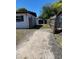 Long driveway leading to a fenced backyard with mature trees; the property offers privacy at 1616 Ferndell Rd, Orlando, FL 32808