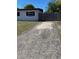 View of the property's side yard and fence, from the long concrete driveway at 1616 Ferndell Rd, Orlando, FL 32808