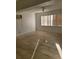 This living room has an air conditioning unit, a window with blinds, and tile flooring at 1616 Ferndell Rd, Orlando, FL 32808