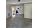 A view of the living room featuring neutral-toned tile flooring and a black chair at 1616 Ferndell Rd, Orlando, FL 32808