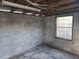 Interior view of the shed with block walls and a single window at 1616 Ferndell Rd, Orlando, FL 32808
