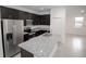 Kitchen showcasing granite counters, stainless appliances, and dark cabinets in an open-concept design at 16815 Sw 41St Avenue Rd, Ocala, FL 34473