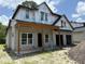 Unfinished two-story home shows the early construction phase with installed windows and open garage at 1702 Arbor Park Dr, Winter Park, FL 32789