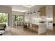 Modern kitchen features a marble island with bar seating, pendant lighting, and stainless steel appliances at 1702 Arbor Park Dr, Winter Park, FL 32789