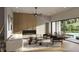 Bright living room boasts a modern fireplace and light hardwood floors with sliding doors to the pool at 1702 Arbor Park Dr, Winter Park, FL 32789