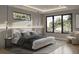 Stylish primary bedroom features a king bed, hardwood floors, modern lighting, and windows at 1702 Arbor Park Dr, Winter Park, FL 32789