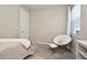 Relaxing bedroom with accent chair, plush carpeting, and comfortable decor at 17667 Saw Palmetto, Clermont, FL 34714