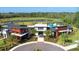 Striking modern clubhouse with community pool, pond view, and palm tree landscaping at 17667 Saw Palmetto, Clermont, FL 34714