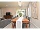 Elegant dining room featuring a wooden table, gray chairs, and modern light fixture at 17667 Saw Palmetto, Clermont, FL 34714