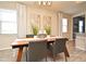 Stylish dining room with wood table, grey chairs, and two modern abstract artworks at 17667 Saw Palmetto, Clermont, FL 34714