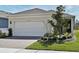 Charming one-story home with a spacious two-car garage, brick driveway and neatly landscaped front yard at 17667 Saw Palmetto, Clermont, FL 34714
