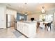 Open-concept kitchen featuring a center island, stainless steel appliances, and seamless flow to the dining area at 17667 Saw Palmetto, Clermont, FL 34714