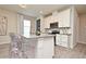 Stylish kitchen featuring a central island with transparent seating and stainless steel appliances at 17667 Saw Palmetto, Clermont, FL 34714