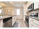 Well-equipped kitchen boasting stainless steel appliances, white cabinetry, and a spacious island with sink at 17667 Saw Palmetto, Clermont, FL 34714