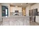 Modern kitchen featuring a spacious island with seating, stainless steel appliances, and bright white cabinetry at 17667 Saw Palmetto, Clermont, FL 34714