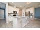 Spacious kitchen with stainless steel appliances, white cabinetry, and a center island with seating at 17667 Saw Palmetto, Clermont, FL 34714