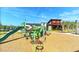 Community playground with a slide, climbing features, and a modern clubhouse in the background at 17667 Saw Palmetto, Clermont, FL 34714