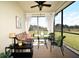 Relaxing screened patio with comfortable seating, a ceiling fan, and views of the lush green backyard at 17667 Saw Palmetto, Clermont, FL 34714