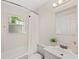 A bright bathroom with a shower/tub combination, white tile, and modern fixtures at 1832 Magnolia Ave, Winter Park, FL 32789