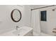 Clean bathroom featuring a shower with blue accent tiles and a shower curtain at 1832 Magnolia Ave, Winter Park, FL 32789