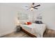 Cozy bedroom with ceiling fan, two windows, bedside table, and plenty of natural light at 1832 Magnolia Ave, Winter Park, FL 32789