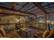 This comfortable outdoor deck includes furniture and a view of the backyard and screened-in pool area at 1832 Magnolia Ave, Winter Park, FL 32789