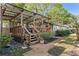 Lovely wooden deck with a metal awning that has outdoor seating and landscaped backyard at 1832 Magnolia Ave, Winter Park, FL 32789