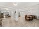 Open-concept dining room with wood floors, modern lighting, and seamless flow to the living and kitchen areas at 1832 Magnolia Ave, Winter Park, FL 32789