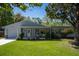 Charming single-story home featuring a well-manicured lawn, covered porch, and inviting curb appeal at 1832 Magnolia Ave, Winter Park, FL 32789
