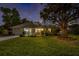 Charming single-story home at dusk, featuring a well-manicured lawn and inviting curb appeal at 1832 Magnolia Ave, Winter Park, FL 32789