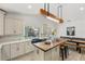 Modern kitchen featuring an island, stainless steel appliances, and a dining area with backyard view at 1832 Magnolia Ave, Winter Park, FL 32789