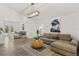 Bright living room with stylish decor, wood flooring, modern lighting, and a comfortable sectional sofa at 1832 Magnolia Ave, Winter Park, FL 32789