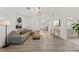 Bright living room with stylish decor, wood flooring, modern lighting, and a comfortable sectional sofa at 1832 Magnolia Ave, Winter Park, FL 32789