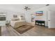Bright main bedroom with ceiling fan, TV, wood-look flooring, and ensuite bathroom access at 1832 Magnolia Ave, Winter Park, FL 32789