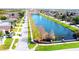 Community with a picturesque lake featuring a fountain, surrounded by tree-lined streets and sidewalks at 1862 Great Falls Way, Orlando, FL 32824
