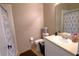 Simple bathroom with a single sink vanity, toilet, and shower with patterned curtain at 1862 Great Falls Way, Orlando, FL 32824