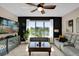 Cozy living room featuring a large window overlooking a pond and a modern entertainment center at 2020 Imperial Eagle Pl, Kissimmee, FL 34746