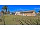 Backyard featuring grass, a fence, and the exterior of the home with access door at 209 Georgetowne Blvd, Daytona Beach, FL 32119