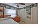 Bedroom with a ceiling fan, dresser, closet, and walls adorned with racing-themed decorations at 209 Georgetowne Blvd, Daytona Beach, FL 32119