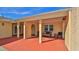 Inviting front porch featuring comfortable seating, decorative pillars, and a red painted patio at 209 Georgetowne Blvd, Daytona Beach, FL 32119