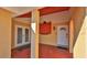 Covered front porch featuring double front door entrance, a single side door, and a red painted patio at 209 Georgetowne Blvd, Daytona Beach, FL 32119