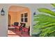 Inviting front porch with comfortable outdoor seating under stucco arch at 209 Georgetowne Blvd, Daytona Beach, FL 32119