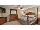 Spacious main bedroom with a full four-poster bed and natural light at 209 Georgetowne Blvd, Daytona Beach, FL 32119