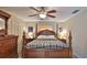 Comfortable main bedroom featuring a full four-poster bed and ceiling fan at 209 Georgetowne Blvd, Daytona Beach, FL 32119