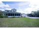 Exterior view of a two-story home with large yard, detached garage, and covered parking at 2877 Absher Rd, St Cloud, FL 34771